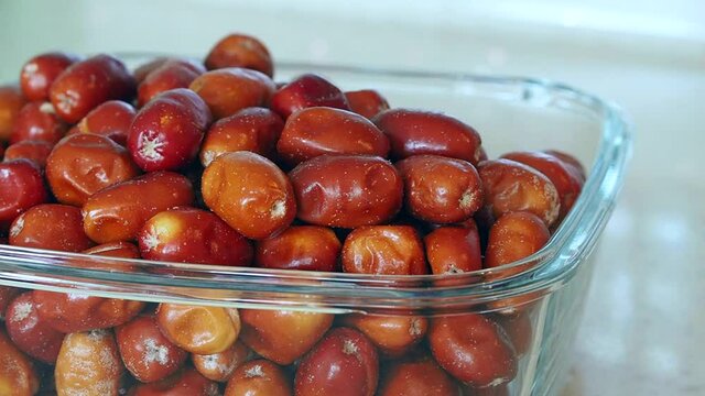 large amount of ripe oleaster fruits, oleaster fruits in a glass bowl,