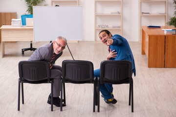 Two male employees in business meeting concept