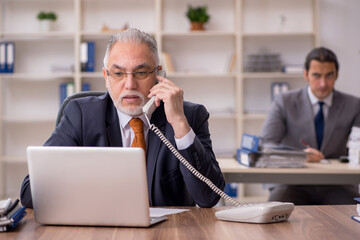 Two employees sitting at workplace