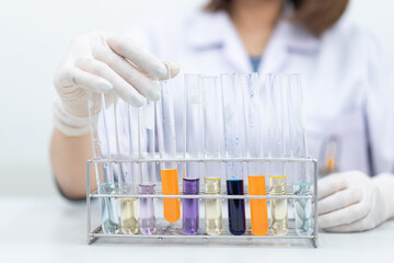 A young woman researcher, doctor, scientist, or laboratory assistant working with plastic medical...