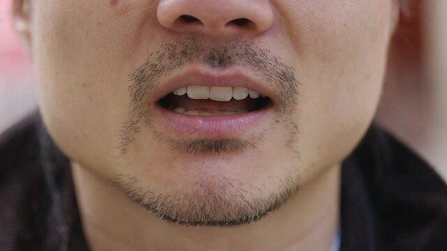 Close Up Shot Of Male Mouth Talking To Camera 