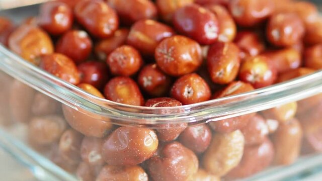 large amount of ripe oleaster fruits, oleaster fruits in a glass bowl,