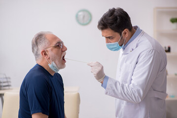 Old male patient visiting young male doctor otorhinolaryngologis