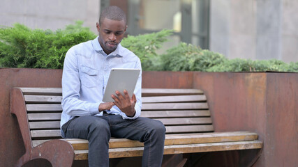 Professional Young African Man Using Tablet Outdoor