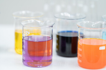 Close-up and selective focus shoot of a microscope, medical test tubes with liquid, and other modern laboratory equipment in a laboratory room. Education stock photo