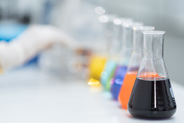 Close-up and selective focus shoot of a microscope, medical test tubes with liquid, and other modern laboratory equipment in a laboratory room. Education stock photo