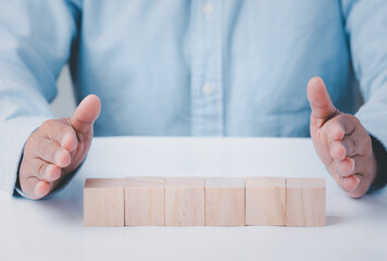 Business hand holding wooden block blank cubes creative idea on table, conceptual development...