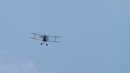 Old vintage flying biplane in the sky