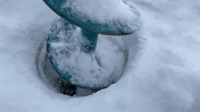 drilling holes in ice close-up