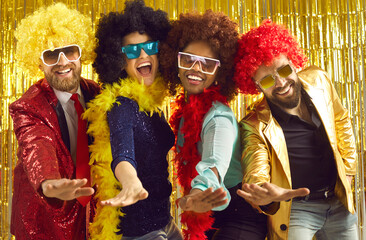 Pop music band singing at night club. Young people disguised in fancy feather boas and funny silly...