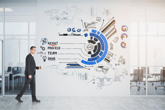 Businessman walking in working space with take away cup of coffe - Powered by Adobe