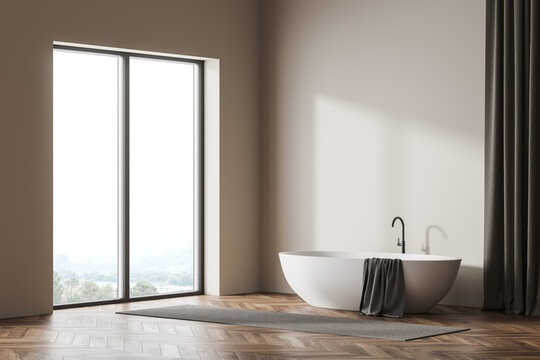 Bright bathroom interior with panoramic window and bathtub