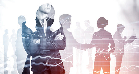 Handsome businessman in crossed hands pose. Colleagues working on background. Pondering how to optimize business process to boost sales of the company. Line charts.