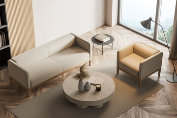 Light living room interior with sofa and armchair on parquet, top view