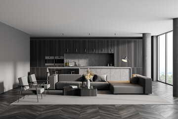 Interior of modern kitchen with wooden parquet, furniture, table and chairs, big couch in the middle of living space, panoramic window. Dining room. Home architecture concept.