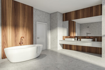 Fototapeta na wymiar Modern Bathroom interior in new luxury home. Stylish hotel room. Open space area. Concrete wooden walls and floor. Bathtub and double sink. White door.