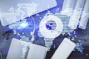 Business theme hologram drawings over computer on the desktop background. Top view. Multi exposure. Concept of international connections.