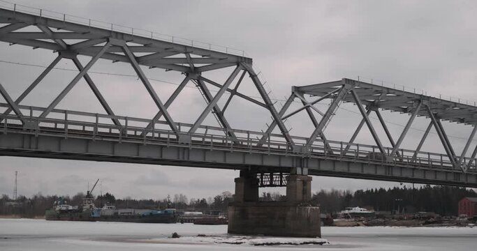 bridge over the river in the village of Ust-Luga on a cloudy winter day
