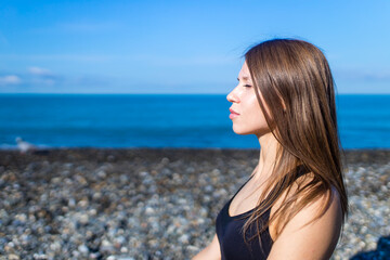 Fototapeta na wymiar doing yoga exercises outdoors at the beach pier in stone beach