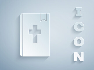 Paper cut Holy bible book icon isolated on grey background. Paper art style. Vector