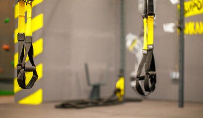 Trx straps in urban modern gym. A fitness equipment called trx that was prepared for playing at noon in a gym.