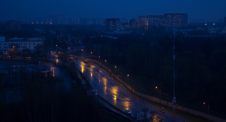 Night road lit by lanterns. Winter landscape