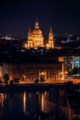 Fototapeta na wymiar Hungary, evening twilight in Budapest, Ishtan Basilica on the background of night city lights, cityscape