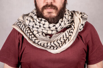 a Young Revolutionary Palestinian Man wearing Traditional keffiyeh or kufiya arround the Neck 