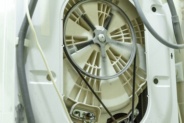 The pulley of the washing machine on the drum at high speeds during operation. Repair of household appliances