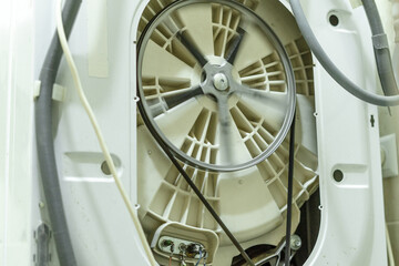 Fototapeta premium The pulley of the washing machine on the drum at high speeds during operation. Repair of household appliances