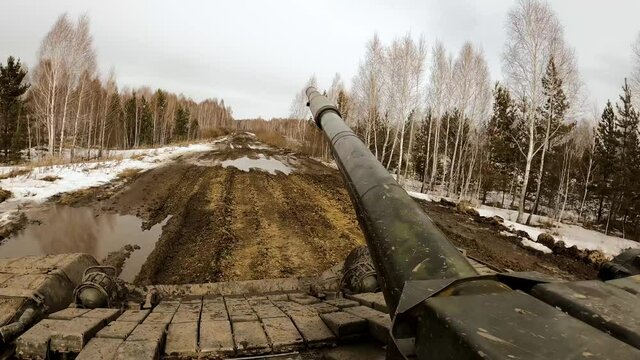 Military tank rides in the forest through the mud, tank biathlon