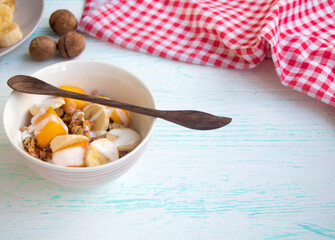 granola with fruit. A healthy breakfast of oatmeal with bananas and mangoes. Healthy nutrition concept. space for text. High quality photo