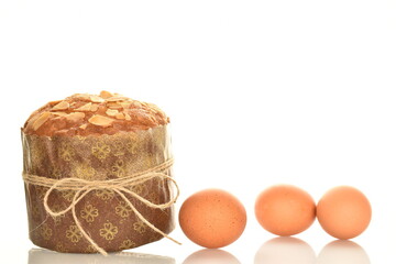 One fresh Easter cupcake with three chicken eggs, close-up, isolated on white.
