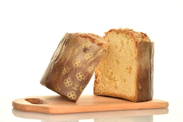 Two halves of a freshly baked Easter cupcake on a cutting board, macro, isolated on white.