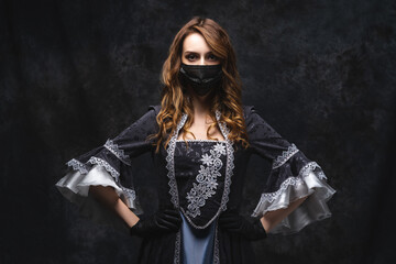 Beautiful woman in renaissance dress, face mask and gloves on abstract dark background, coronavirus, covid-19 protection concept