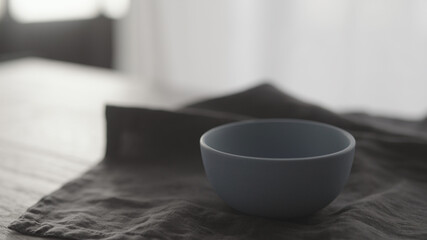 blue ceramic bowl on linen cloth