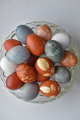 Colorful beautiful Easter eggs on a glass plate