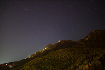 Obraz na płótnie Canvas Night sky with stars over a mountain in Russia