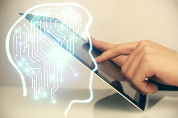 Double exposure of man's hand holding and using a digital device and brain hologram drawing. Data concept.