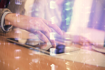 Double exposure of data theme hologram drawing and man and woman working together holding and using a mobile device.