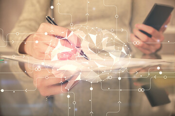 Double exposure of brain sketch hologram and woman holding and using a mobile device.