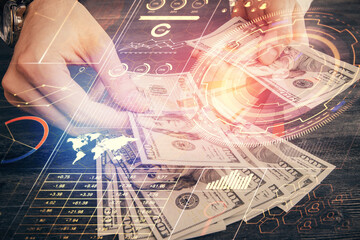 Double exposure of technology drawing hologram and us dollars bills and man hands. Data concept