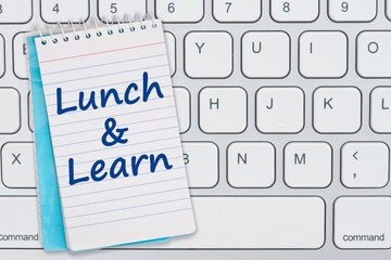 Lunch and Learn message blue notepad on gray keyboard