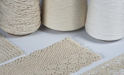 Vintage lace on the background of spools with thread