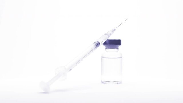 small glass bottle and syringe with the vaccine or medical supplies on a white background (looping)