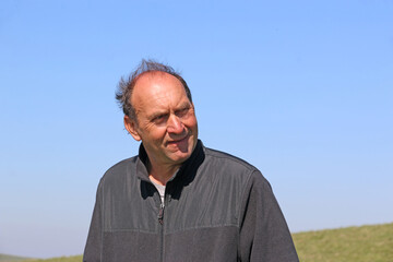 portrait of a man smiling outside