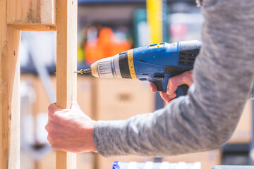 Do it yourself: Home Handyman is using a cordless screwdriver for screwing