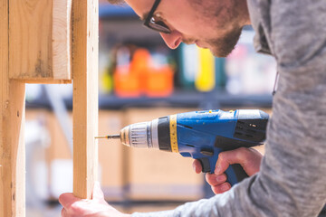 Do it yourself: Home Handyman is using a cordless screwdriver for screwing