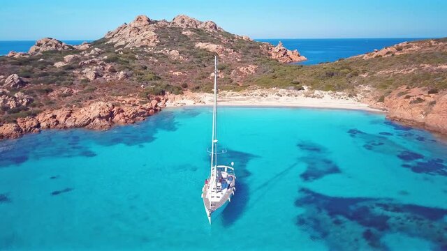 View from above, stunning aerial view of some sailboats sailing on a beautiful turquoise sea. Mortorio Island, (Isola di Mortorio, Sardinia, Italy.