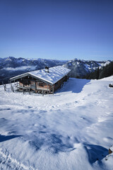 Fototapeta na wymiar Wonderful wooden hut in snow covered mountains